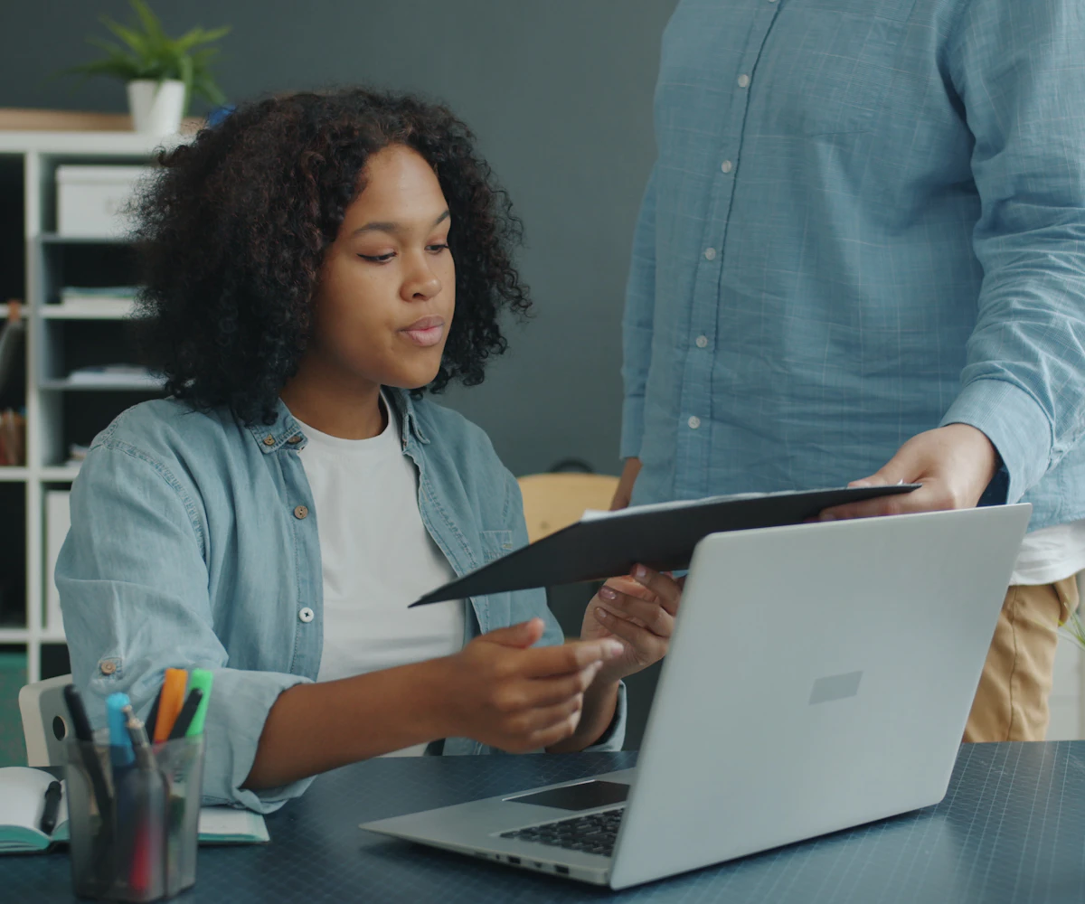 Two colleagues reviewing business data together at a desk